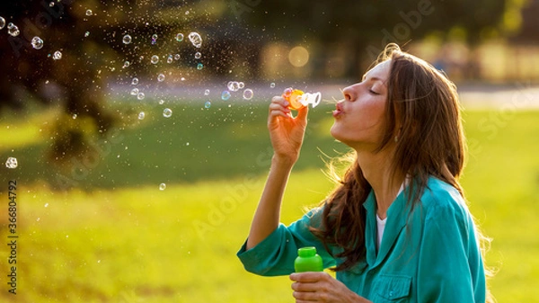 Obraz Beautiful girl blowing soap bubbles