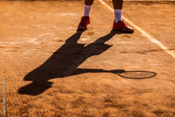 Fototapeta shadow of a tennis player preparing to serve