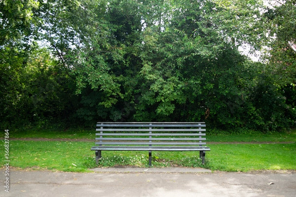 Fototapeta Empty bench in a park