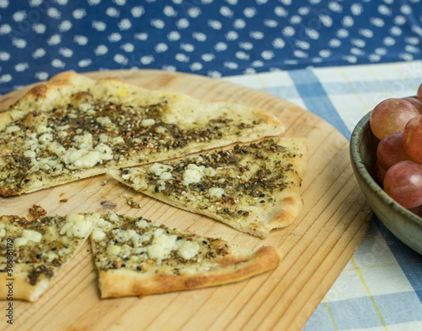 Obraz Hot from the oven flatbread with Za'atar herbs and feta cheese as topping.  