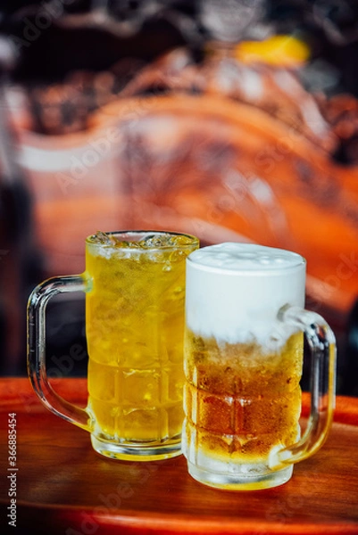 Obraz Butter beer and Chrysanthemum Tea in tall glass on wood table.