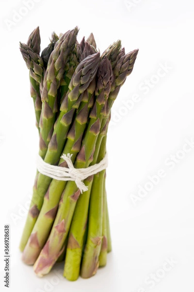 Obraz Heap of fresh asparagus isolated. Fresh vegetables. Top view.