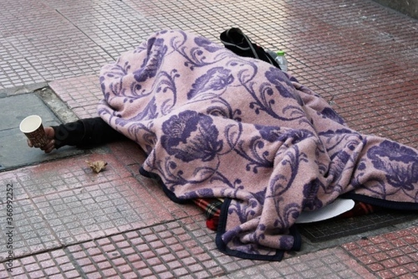Fototapeta Greece, Athens, February 1 2020 - An unidentified homeless person begging for money in the center of Athens.