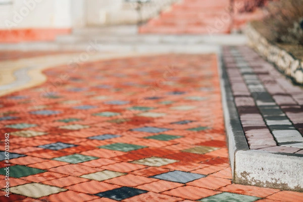 Fototapeta Stone pavement in perspective. Stone pavement texture. Granite cobblestoned pavement background. Abstract background of a cobblestone pavement