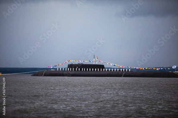 Fototapeta A line of modern russian military submarine cruisers in the row, northern fleet and baltic sea fleet in the open sea, submarine during military exercise