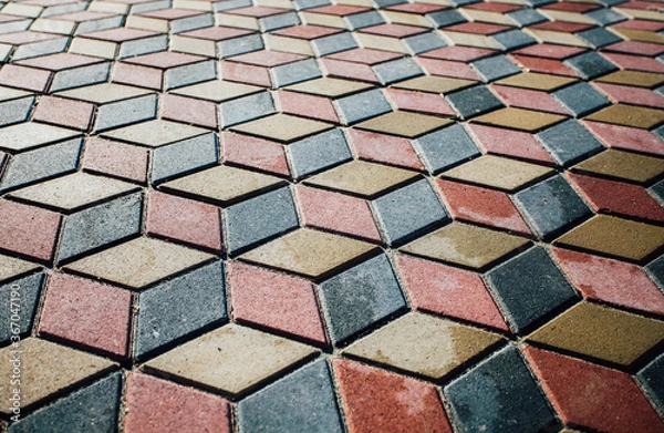 Fototapeta Stone pavement in perspective. Stone pavement texture. Granite cobblestoned pavement background. Abstract background of a cobblestone pavement