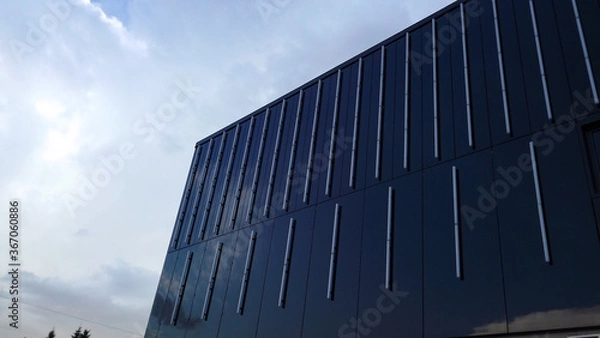 Obraz black facade of the building against the blue sky