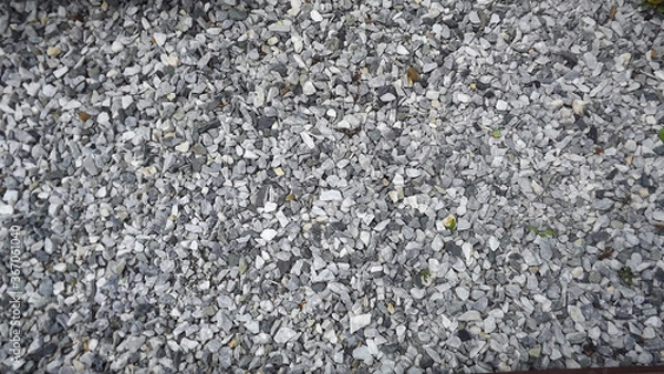 Obraz scattered small gray stones on all photos