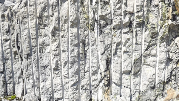 Obraz a fragment of grey rock with traces of processing