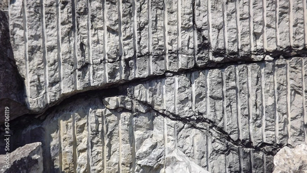 Obraz a fragment of grey rock with traces of processing