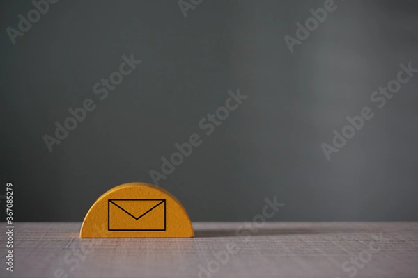 Fototapeta Mail symbol on  a wooden cube over the grey background