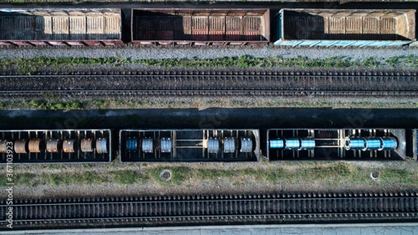 Fototapeta Aerial view of rail sorting freight station with railway cars, with many rail tracks railroad. Heavy industry landscape.