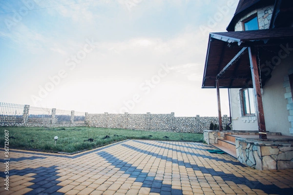 Fototapeta Stone pavement in perspective. Stone pavement texture. Granite cobblestoned pavement background. Abstract background of a cobblestone pavement