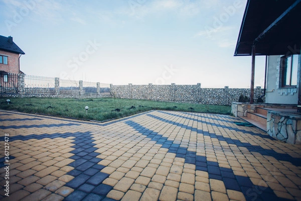 Fototapeta Stone pavement in perspective. Stone pavement texture. Granite cobblestoned pavement background. Abstract background of a cobblestone pavement