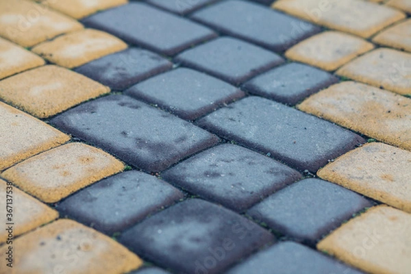 Fototapeta Stone pavement in perspective. Stone pavement texture. Granite cobblestoned pavement background. Abstract background of a cobblestone pavement