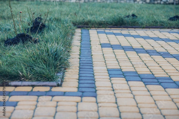Fototapeta Stone pavement in perspective. Stone pavement texture. Granite cobblestoned pavement background. Abstract background of a cobblestone pavement