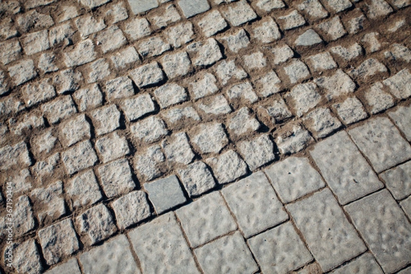 Fototapeta Nested pavers of various colors, around the grass is green, chic garden