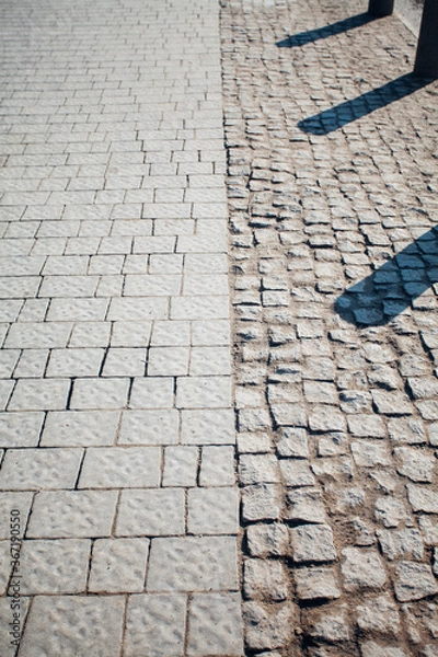 Fototapeta Nested pavers of various colors, around the grass is green, chic garden
