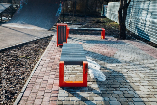 Fototapeta Nested pavers of various colors, around the grass is green, chic garden