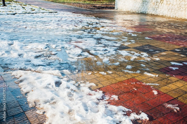 Fototapeta Nested pavers of various colors, around the grass is green, chic garden