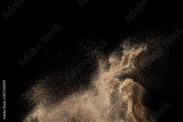 Obraz Gold sand explosion isolated on black background. Abstract sand cloud.
