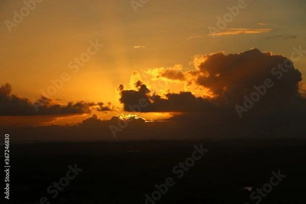 Fototapeta sunset behind clouds