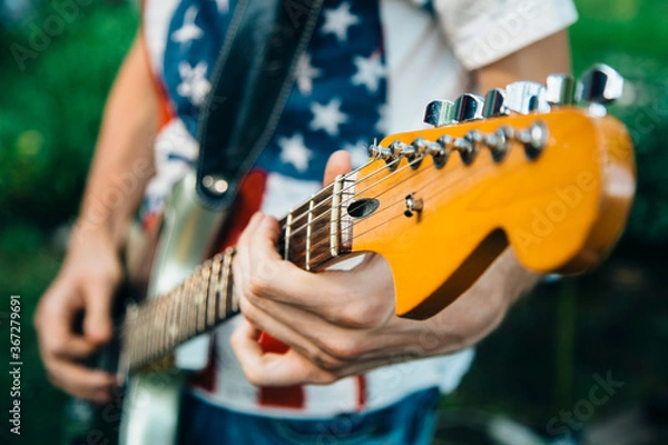 Obraz man playing guitar at black background