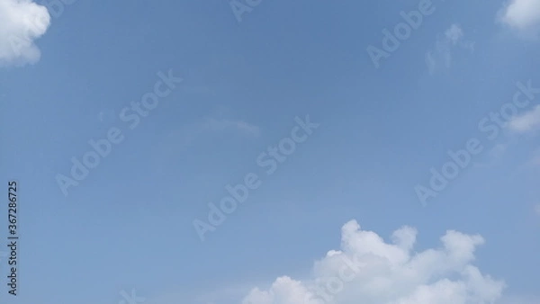 Fototapeta beautiful white clouds minimal in the blue sky, natural wallpaper, nature's background for printing back-cover designs and poster