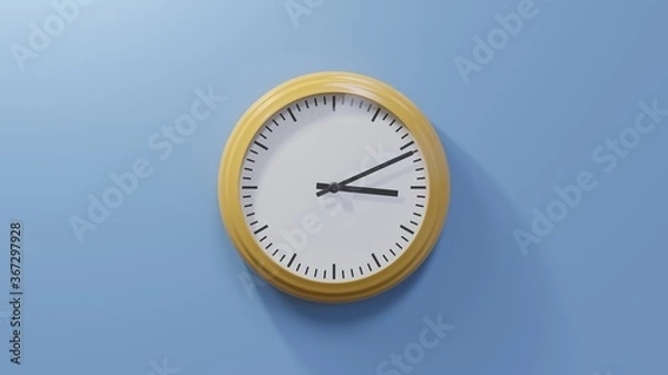 Fototapeta Glossy orange clock on a blue wall at eleven past three. Time is 03:11 or 15:11