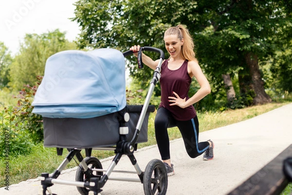 Obraz Young active mother doing her exercises with stroller on a walk