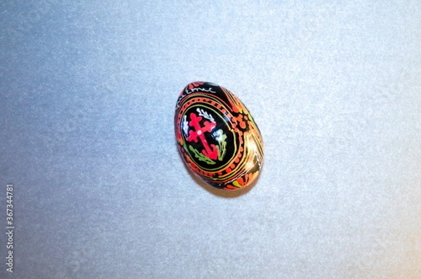 Fototapeta Easter painted egg with the inscription Jesus Christ and the cross for the Easter holiday congratulations with free space for text