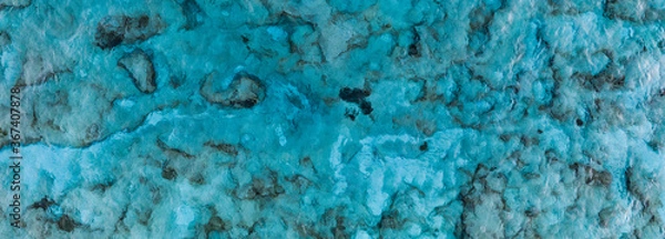 Obraz An aerial view of the beautiful Mediterranean sea, where you can se the rocky textured underwater corals and the clean turquoise water of Cyprus, Horizontal Shot for banner or backround