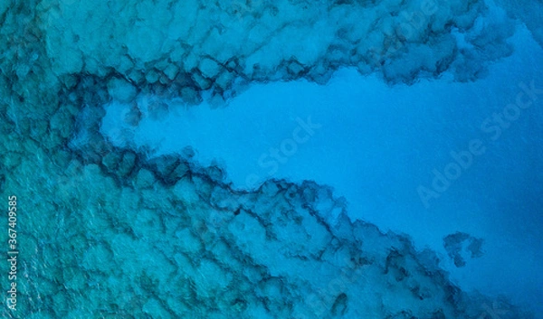 Obraz An aerial view of the beautiful Mediterranean sea, where you can se the rocky textured underwater corals and the clean turquoise water of Cyprus