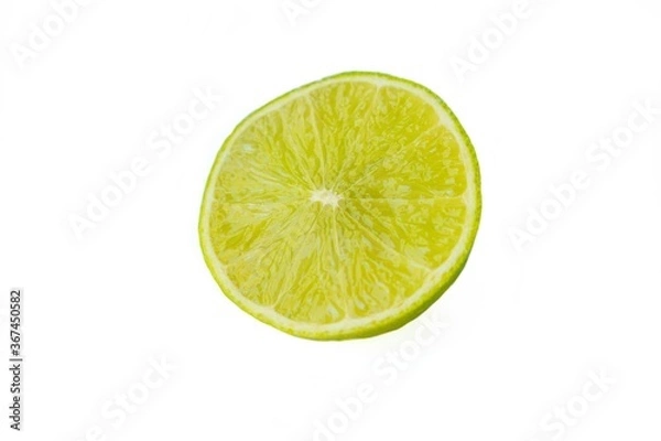 Fototapeta Bright juicy sour lime on a white background cut in half.