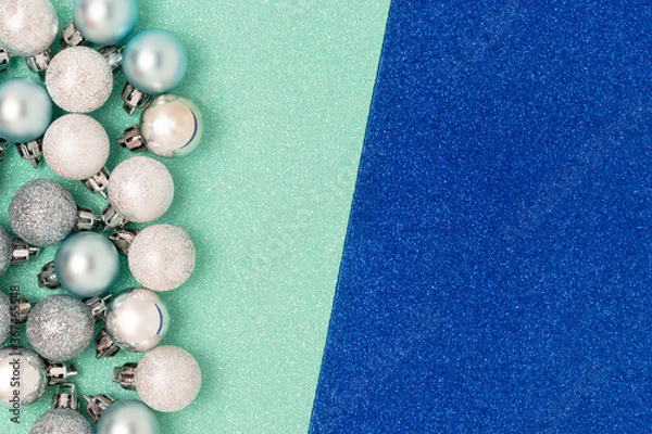 Fototapeta Set of Christmas balls on a colorful glowing textured background. Creative concept with place for your text.