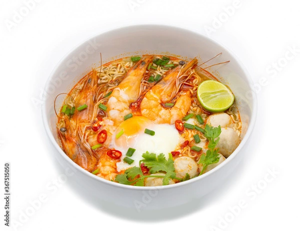 Fototapeta Tom yum kung or hot and spicy shrimp soup boiled with noodle and ingredient inside, in the white bowl.