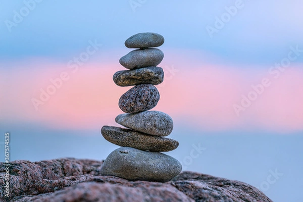 Obraz A small cairn placed on a rock at sunset