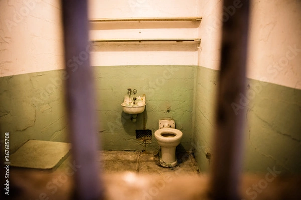 Fototapeta old prison cell behind bars