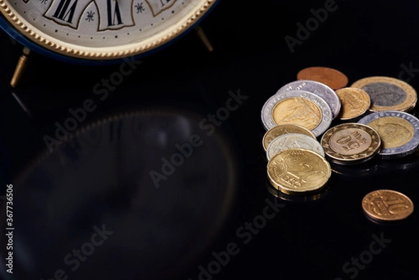 Obraz clock and coins on black glass
