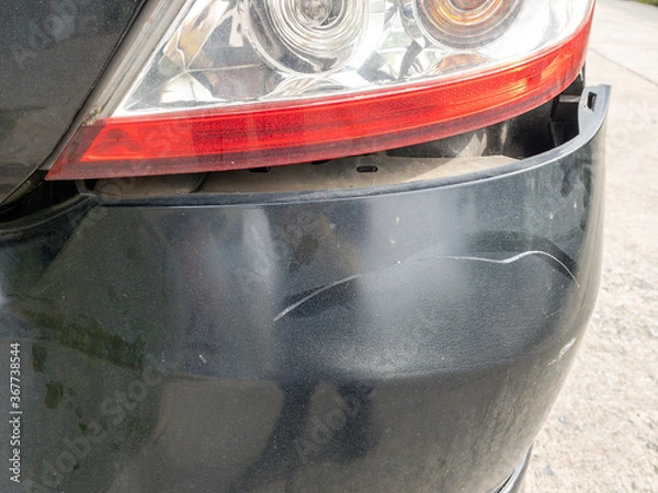 Fototapeta Back side of black color car damaged and broken by accident on road parking can not dirve any more.