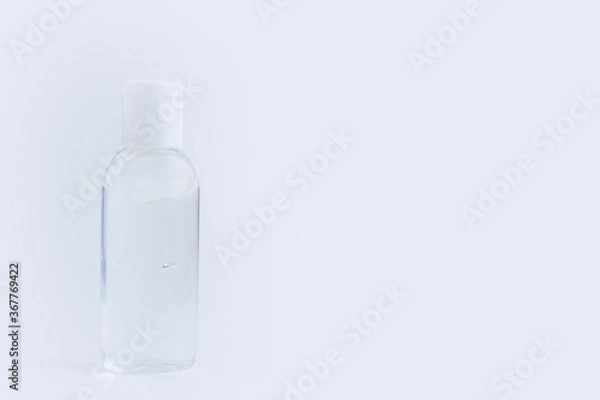 Obraz Bottle of instant antiseptic hand sanitizer transparent gel isolated on gray white background, no label. Antibacterial, hydro alcoholic gel, ethyl alcohol. Mini travel pocket small size. Banner.