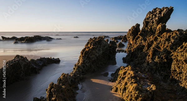 Obraz Rocks illuminated by the sun on the beach