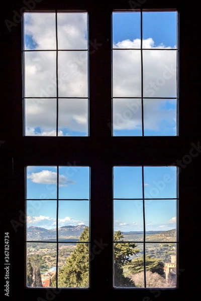 Obraz Outside the window you can see a beautiful landscape with clouds