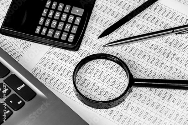 Fototapeta business office desk closeup - financial reports, analysis and accounting, set of documents, tables and graphs, various items for bookkeeping, calculator