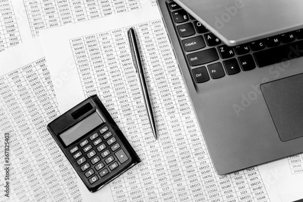 Fototapeta Top view of working space with financial reports, laptop, calculator and pen. Top view. Business planning concept on white.