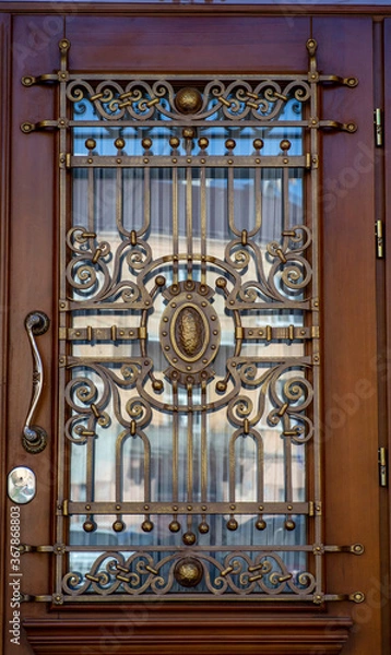 Fototapeta old and modern decorative forged metal elements of fences, gates, window gratings