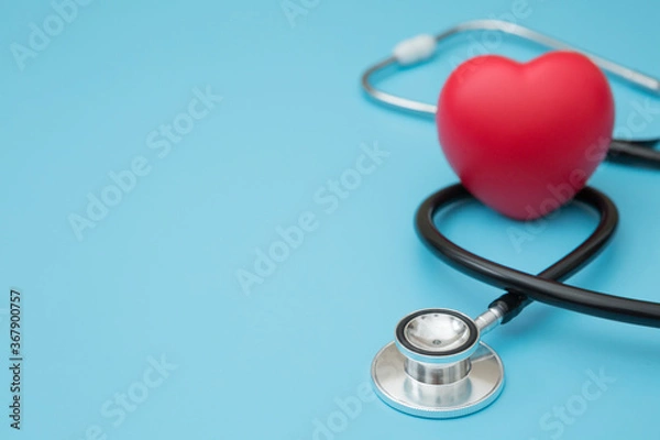 Fototapeta Heart shaped squeeze ball for hand muscle exercise and stethoscope  on blue background and copy space