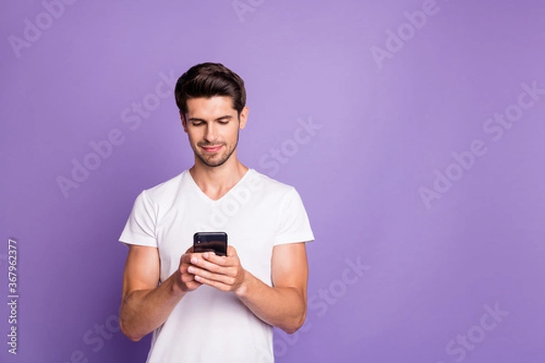 Fototapeta Portrait of his he nice attractive cute focused guy using digital device sending sms free time isolated over bright vivid shine vibrant violet lilac purple color background