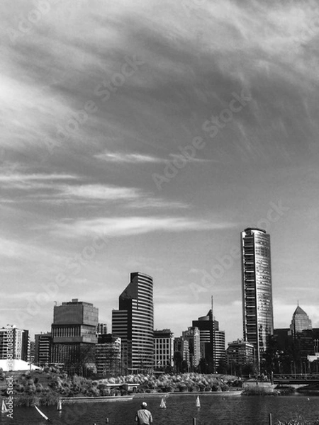Fototapeta Men fishing, Santiago skyline with sky with clouds (in black and white)