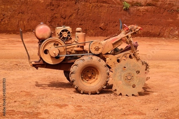 Fototapeta Laterite cutting machine in the mining field.laterite is a soil and rock type rich in iron and aluminium and is commonly considered.it is a red stone for building constructions in kerala